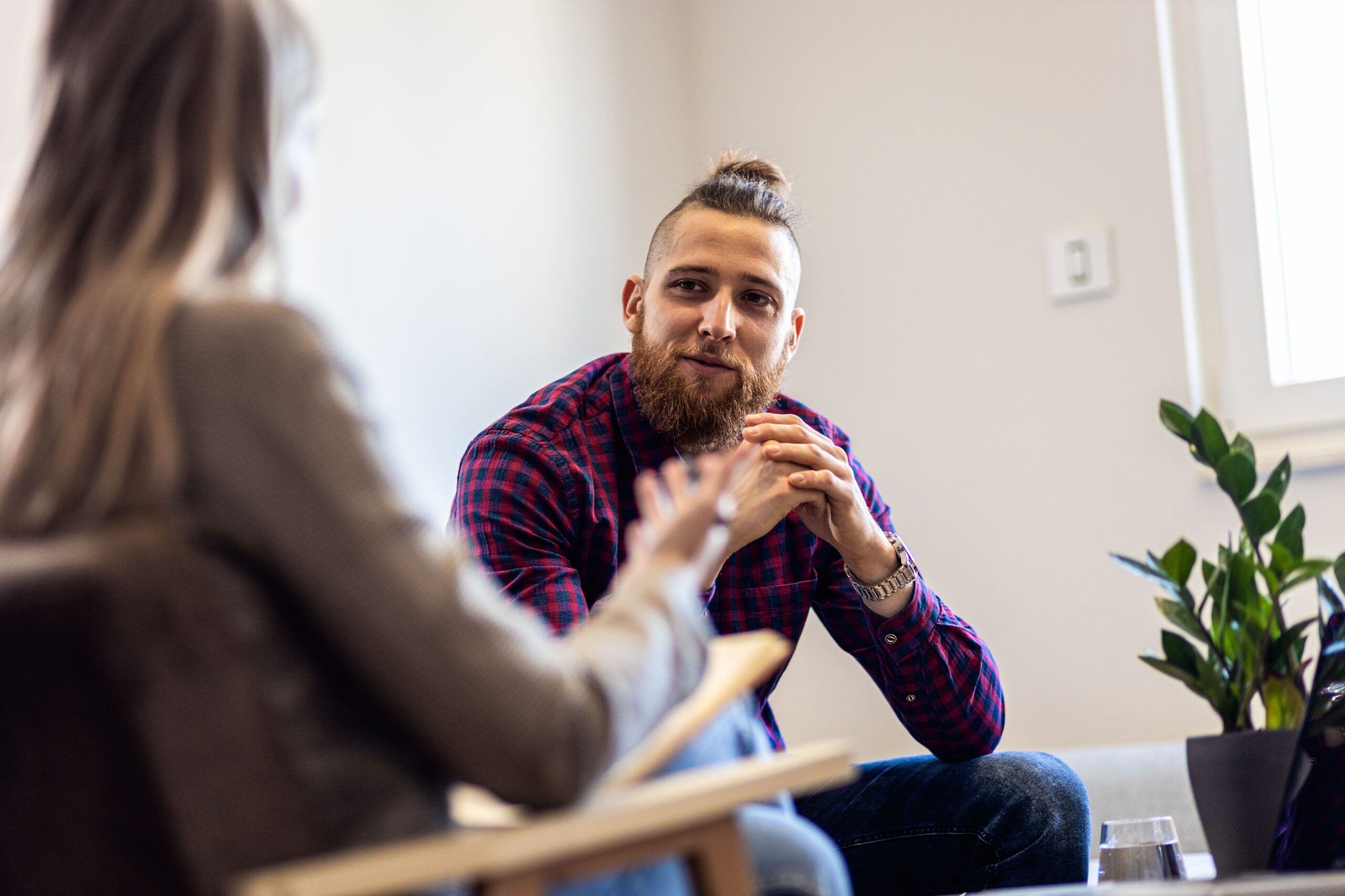 A man talks to therapist in Aetna rehab in Colorado.