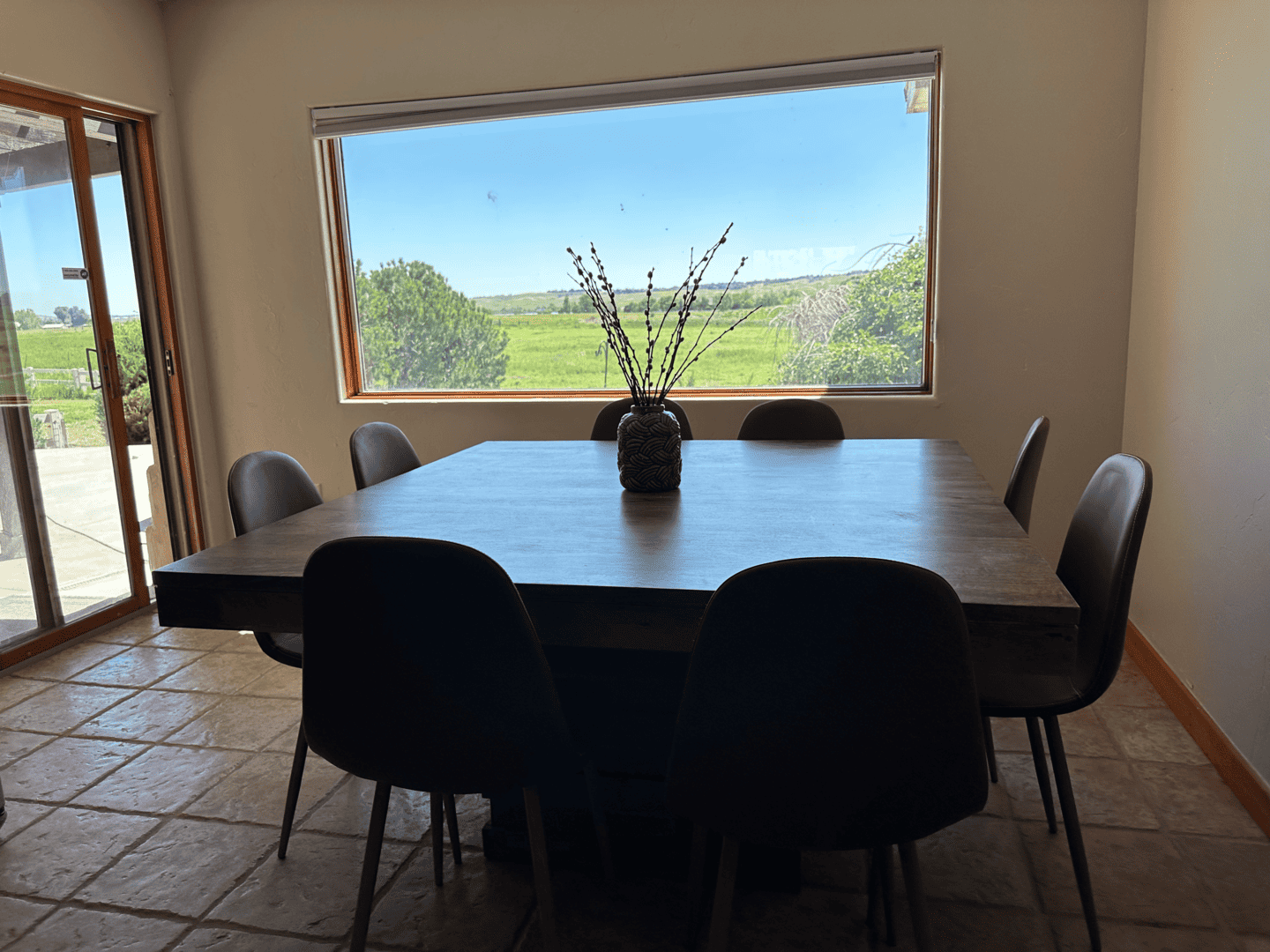 dining table with doors leading to patio