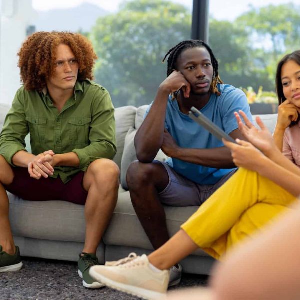 A group participates in longmont rehab through a group therapy session.
