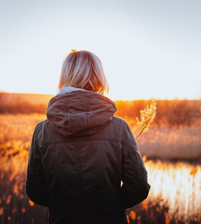 A woman enjoys a sunset after completing our Intensive Outpatient Program Boulder Colorado