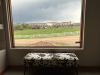 cow print bench and window with view of ranch outside