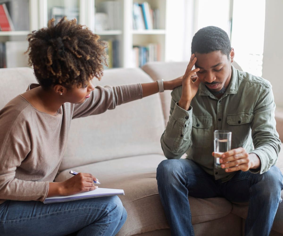 A therapist supports a man facing substance abuse at a rehab in Denver, Colorado.