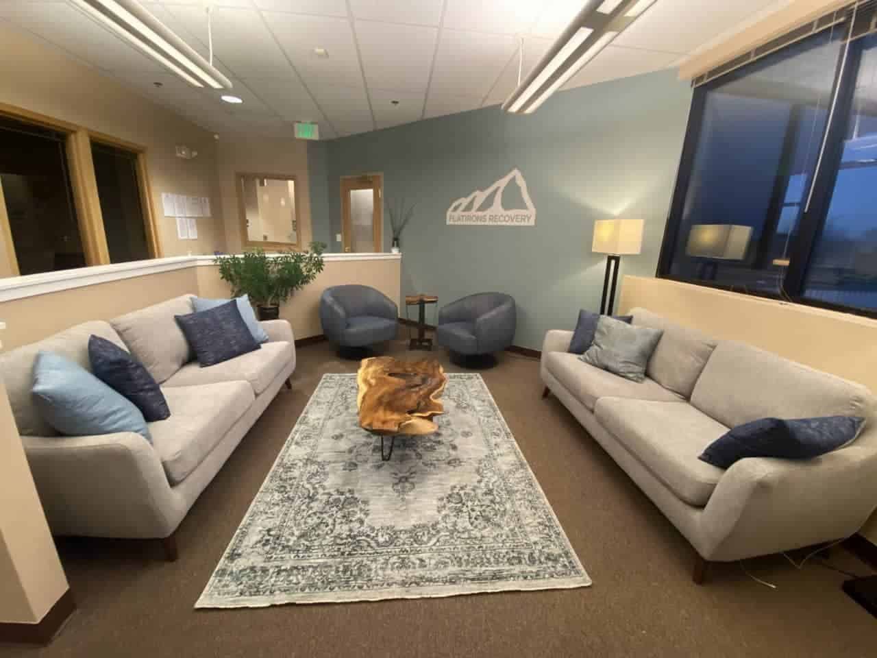 waiting room with couches, chairs, and coffee table