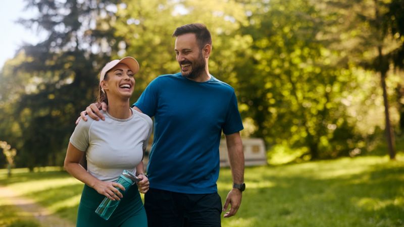 A couple enjoys a hike during holistic therapy through detox vs rehab