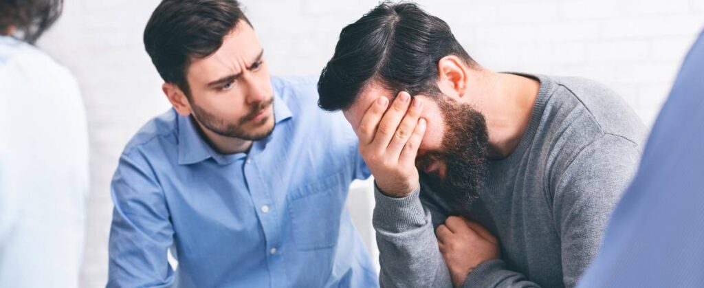 A man supporting a friend during drug addiction treatment in Boulder, Colorado.