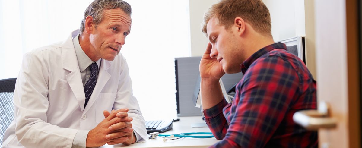 A young man talking to his doctor during opiate detox. 