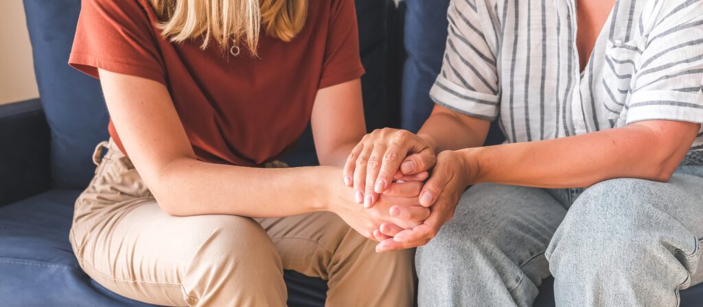 Two people comfort eachother during depression treatment in Boulder, Colorado