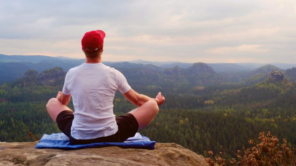 A man meditating outdoors as part of ACT therapy in Boulder, Colorado.