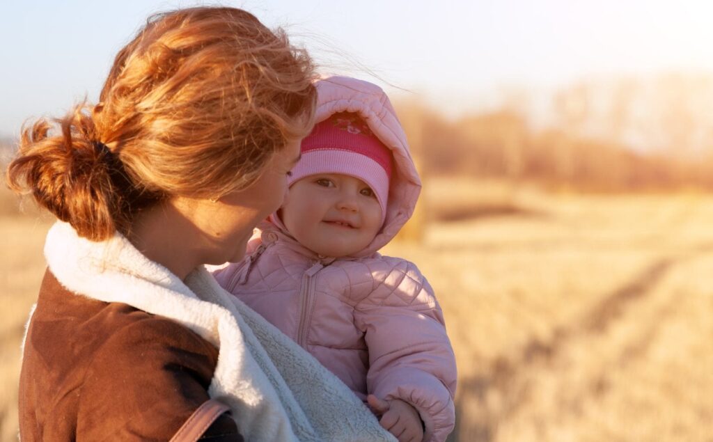 Mother enjoying a happy moment with her baby after postpartum depression treatment in Boulder.