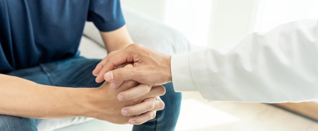 A man is comforted while making his decision on which type of treatment is right for him by consulting with his doctor.