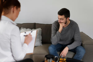 Man resting his hand on his chin during a consultation of treatment for stimulant-induced anxiety