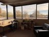 office with desk, shelves, and chairs