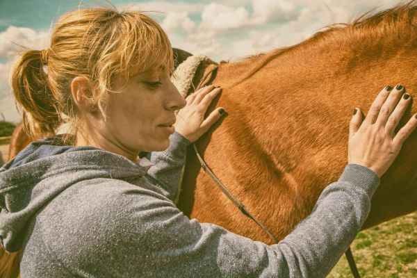 woman works with horses during experiential therapy in Boulder, Colorado